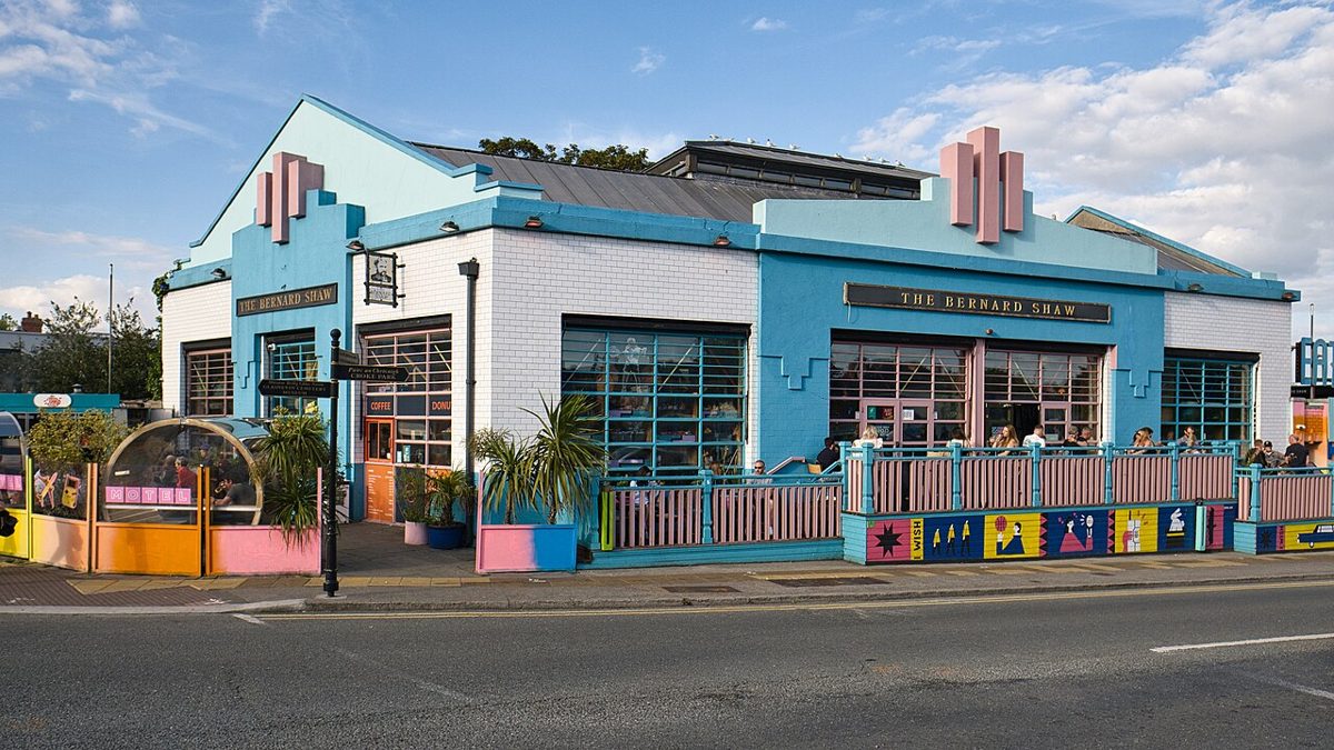 The Bernard Shaw's blue and pink building at Cross Guns Bridge, with its painted yard fence